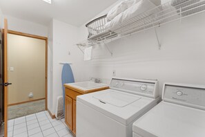 A laundry room with two washing machines, a drying rack, and a sink. - Spacious 5BR Wildernest Home | Private Hot Tub & Views (Silverthorne)