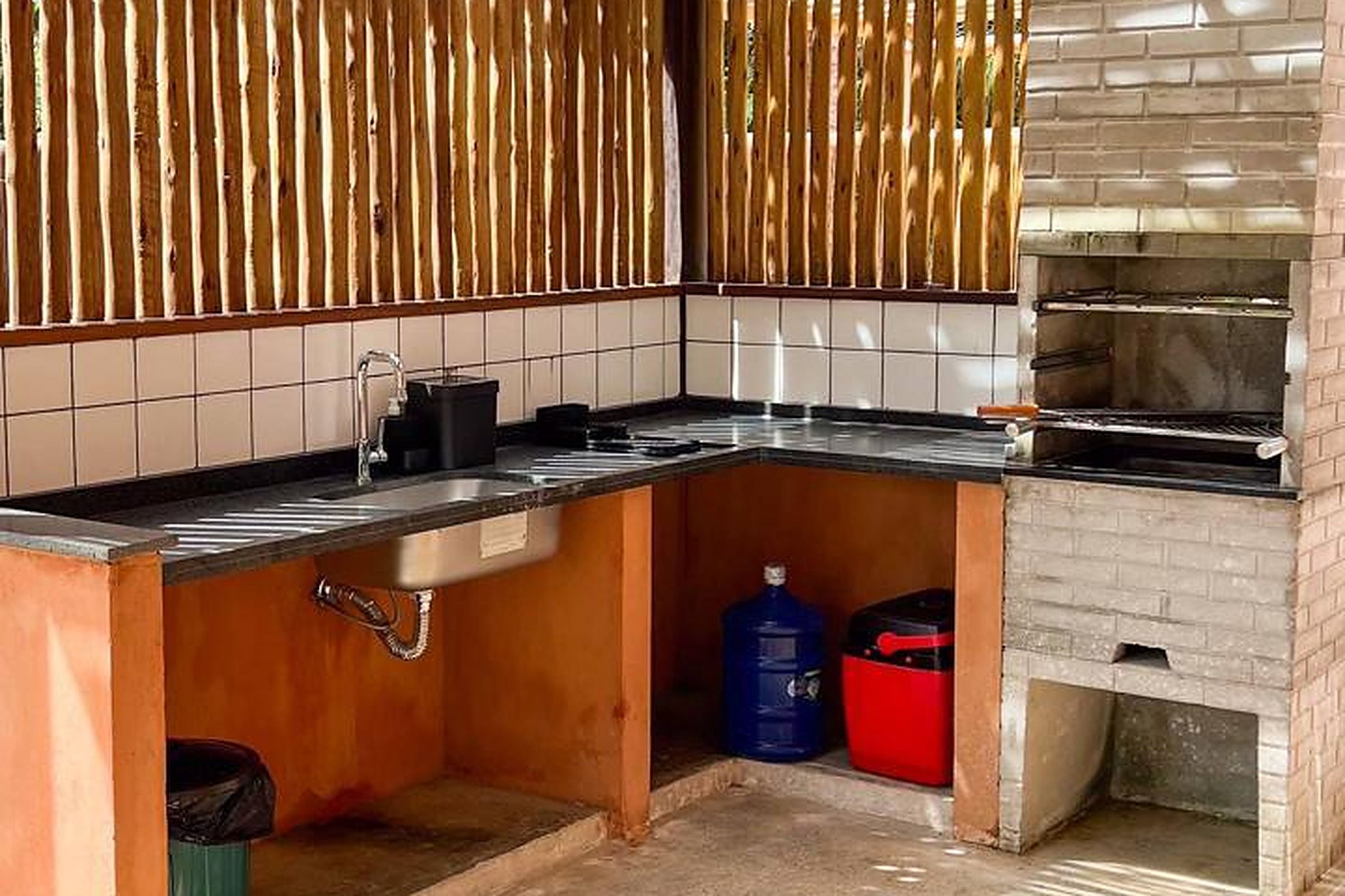 A compact kitchen with a built-in oven, a sink, and a countertop.