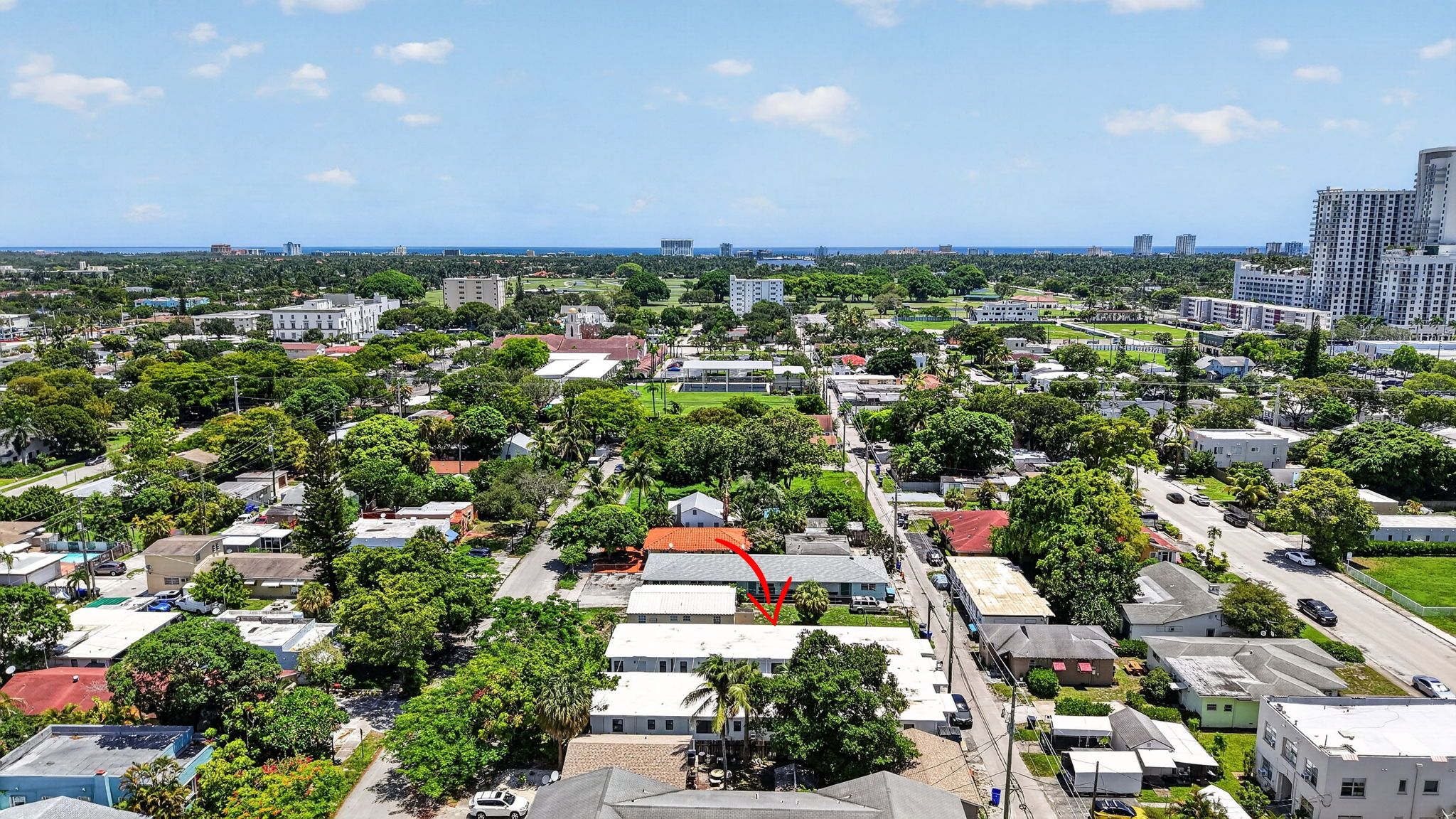 A residential area with houses, roads, and greenery.
