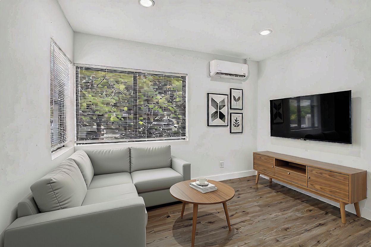 Una sala moderna con un sofá, una mesa de centro, un televisor y un mueble de madera.