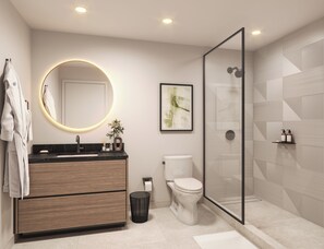 Une salle de bain moderne avec un grand miroir rond, des toilettes, une douche et un meuble-lavabo avec un évier.
