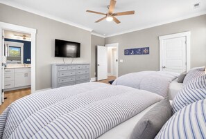 A bedroom with a bed, a ceiling fan, a television, and a door. - NEW! Ocean Views-Steps to Beach-Pool+Spa-Luxury 8BR (Atlantic Beach)