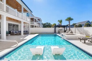 A swimming pool with lounge chairs, a covered patio, and a white fence. - NEW! Ocean Views-Steps to Beach-Pool+Spa-Luxury 8BR (Atlantic Beach)