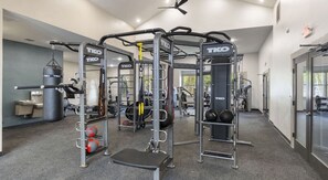 A gym with TKO branded equipment, a punching bag, and a weightlifting area. - Spacious 3-bedroom apartment in Houston (Houston)