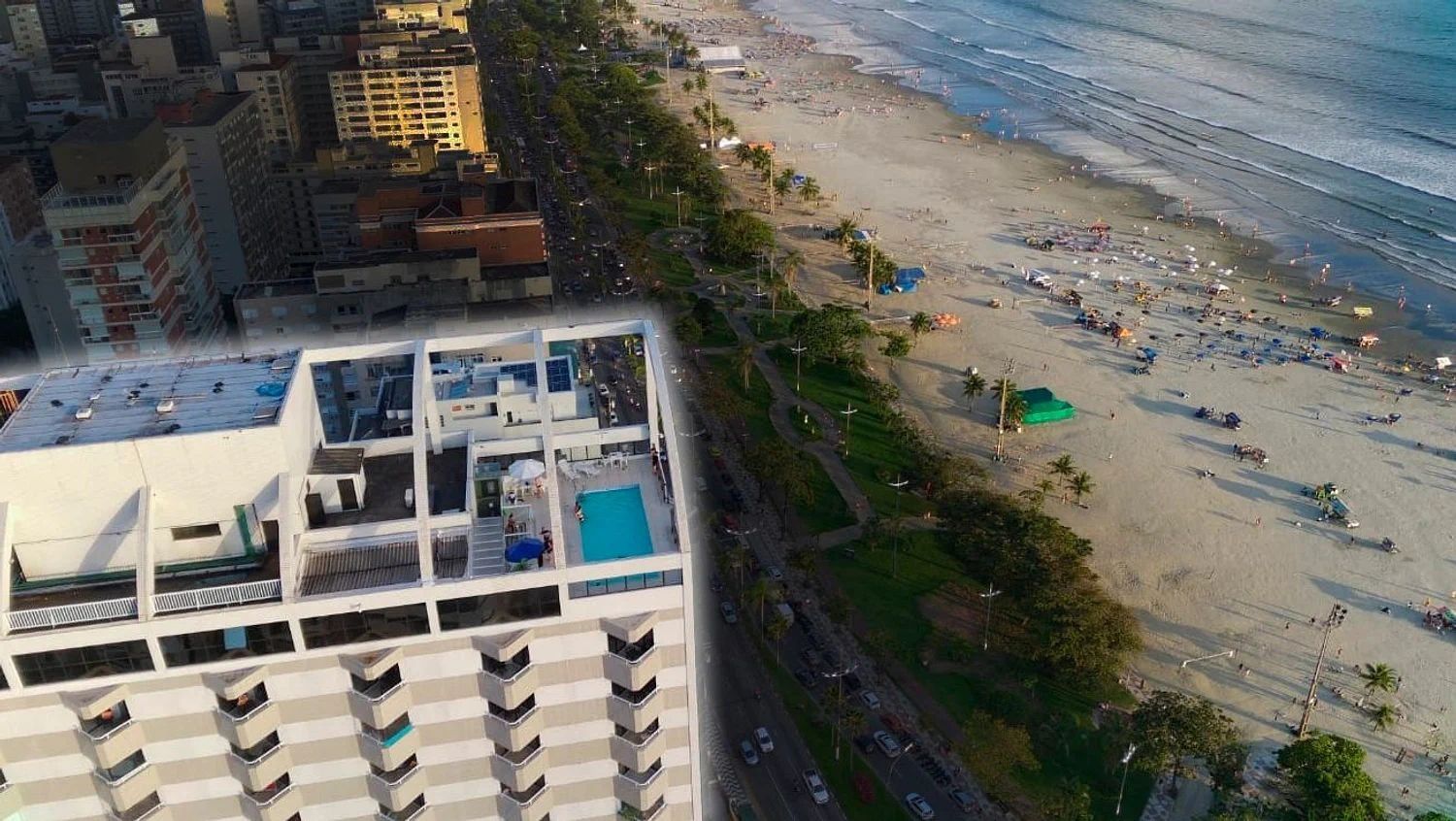 A high-rise hotel with a rooftop pool and a beach view.
