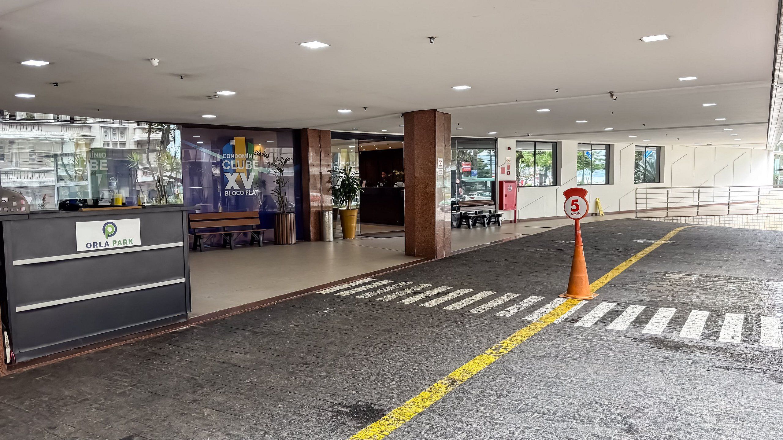 A hotel reception area with a sign for 'Orla Park' and a speed limit sign indicating 5 km/h.