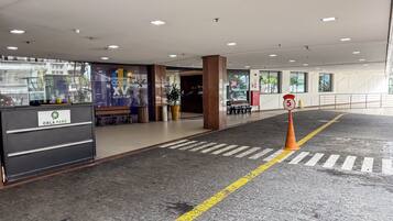 A hotel reception area with a sign for 'Orla Park' and a speed limit sign indicating 5 km/h.