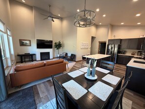 A modern kitchen with dark cabinetry, stainless steel appliances, and a central island. - Seeley Lake Mountain Modern (Seeley Lake)