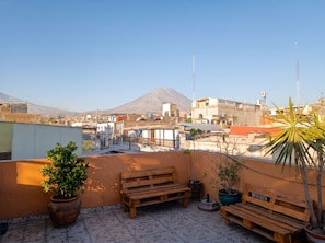 A rooftop terrace with a view of a cityscape and a mountain in the distance. - homesweethome (Arequipa)