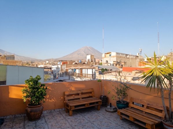 A rooftop terrace with a view of a cityscape and a mountain in the distance. - homesweethome (Arequipa)