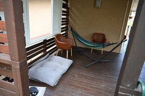 A wooden deck with a hammock, two chairs, and a small rug. - Lakeview Retreat, Deck & Room to Unwind | Get Back 2 Basics Rathmines (Rathmines)