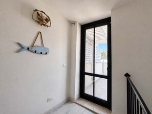 A room with a black-framed window, a wall-mounted fish decoration, and a white electrical outlet. - The Secret Garden, villa with private garden (San Vito Lo Capo)