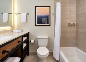 A bathroom with a toilet, sink, vanity, and a bathtub. - Ski in Ski out Resort at base of Steamboat Springs (Steamboat Springs)