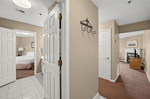 Hallway leading to the bedroom and the living area with a fireplace. - Cozy Pigeon Forge Condo w/ Kitchen & Balcony (Pigeon Forge)