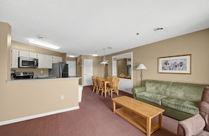 A compact living space with a kitchenette, dining area, and seating area. - Mountain View Condo with Fireplace & Balcony (Pigeon Forge)