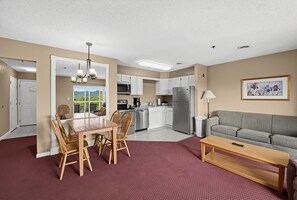 A compact apartment with a dining area, kitchenette, and living space. - Mountain View Condo w/ Balcony | Near Dollywood! (Pigeon Forge)