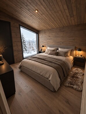 A bedroom with a large window, wooden ceiling, and a bed with multiple pillows. - Ruka Timber Chalets  (Kuusamo)
