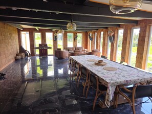 A dining area with a long table, chairs, and a fireplace. - New Listing (Puerto montt)
