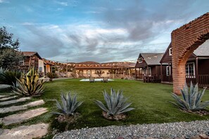 A residential property with a swimming pool, a patio area, and a well-maintained lawn. - Long Stay Cabin 2 - by Hacienda Cuatro Milpas (Ensenada)