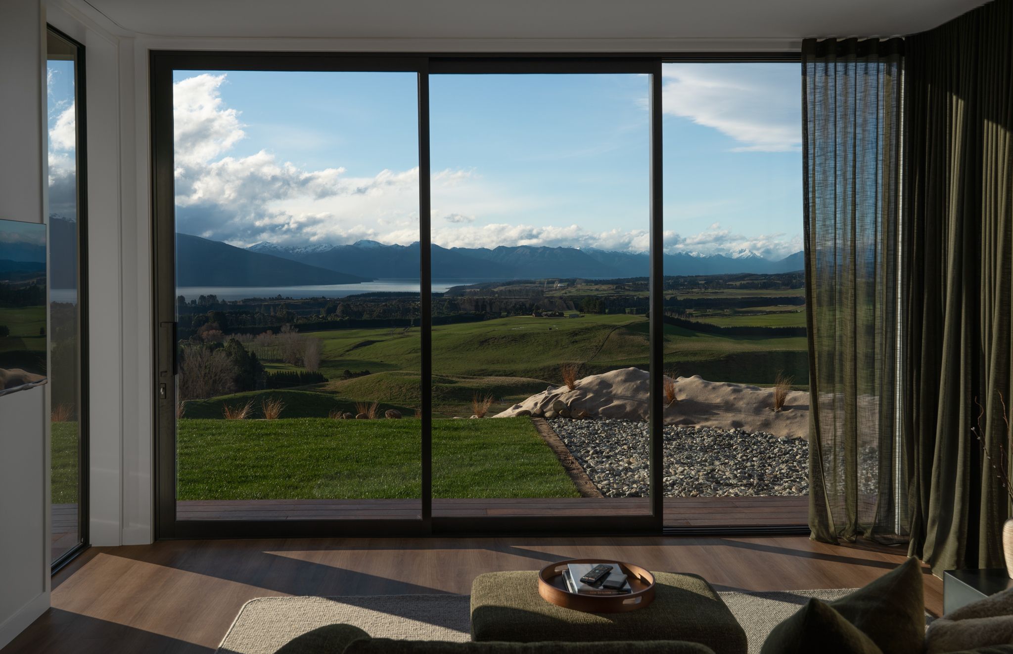 A room with a large sliding glass door leading to a scenic outdoor view.