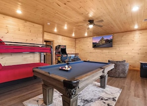 A wooden interior with a pool table, bunk beds, and a ceiling fan. - What a Wonderful World * 2 bed * 3 bath * sleeps 6 (Sevierville)