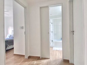 A hallway leading to a bedroom with a bed and a bathroom visible through an open door. - 25- Modern Space in Palermo Soho w/Pool (Buenos Aires)