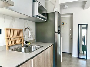 A modern kitchen with a stainless steel sink, a built-in microwave, and a refrigerator. - 28- Incredible Oriental Style Apt. /Palermo Soho (Buenos Aires)
