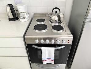 A kitchen with a stove, kettle, and coffee maker. - 201- Modern Apt. w/ Great Amenities in Palermo (Buenos Aires)