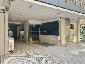 A modern building entrance with a tiled floor, glass doors, and a visible interior space. - 29- Unbeatable Apt w/Amenities on Terrace - Palermo (Buenos Aires)