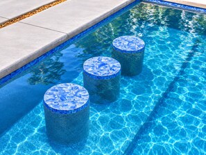 A clear blue pool with three circular steps leading into the water. - Sarasota Coastal Retreat (Sarasota)