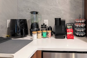 A kitchen with a coffee maker, blender, and various food items on the counter. - Monthly friendly Lux 1BR 20 Min NYC 4 min to Prud (Newark)