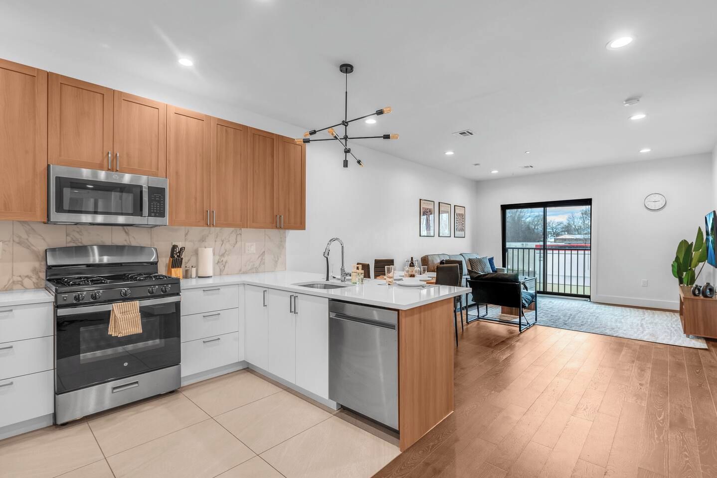 A modern kitchen with a built-in oven, microwave, and dishwasher.