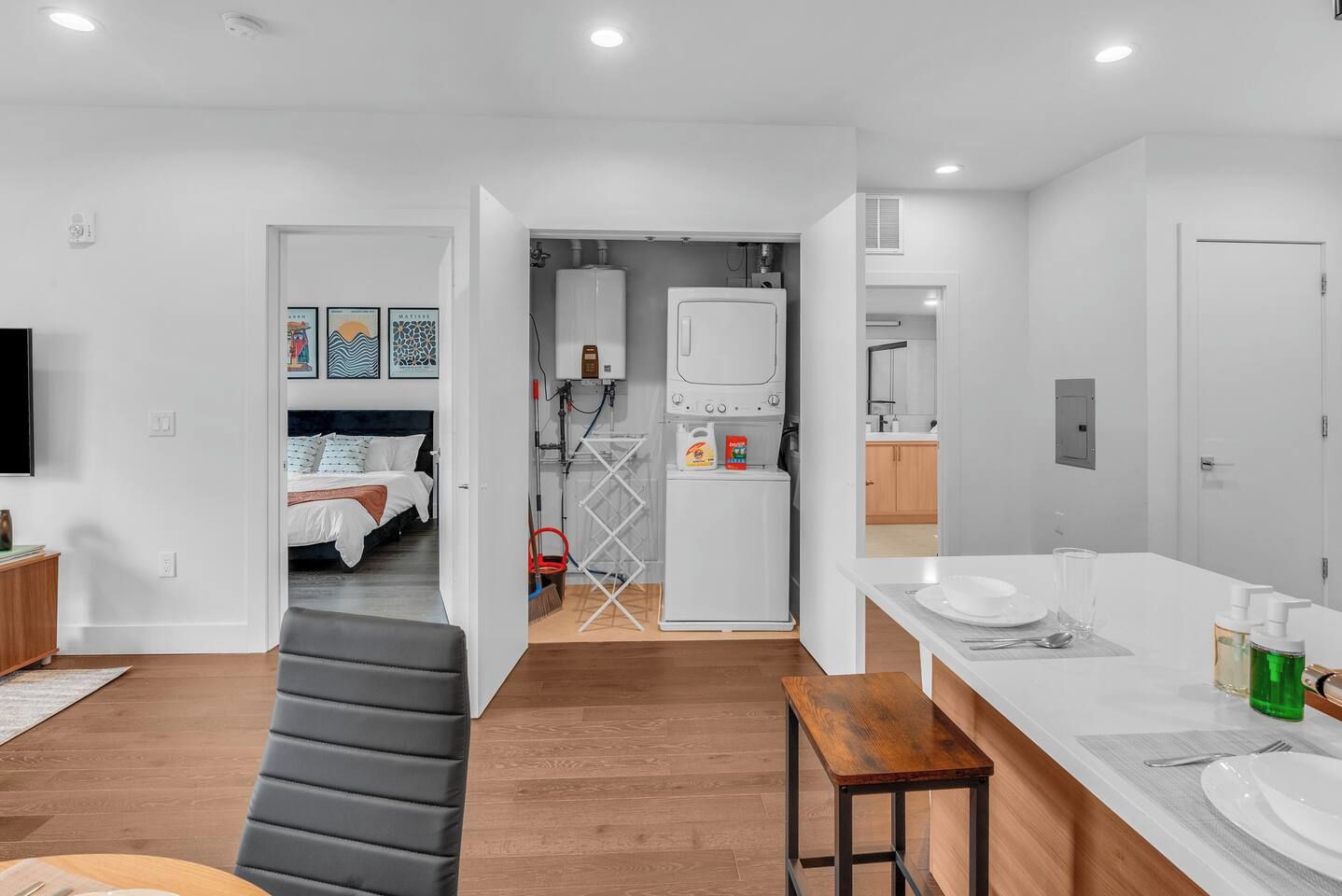 A modern interior with a bed, a dining area, and a kitchen.