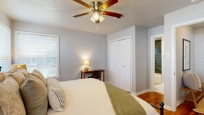 A bedroom with a bed, a desk, a chair, a ceiling fan, and a wardrobe. - Brazos Outpost ~ Ultimate Yard ~ 3BR/2BA (Bryan)