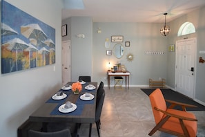 A dining area with a table set for four, a bench, and a chair. - 5BR Gleenbrook Home w/ Private Pool&Spa and games (Clermont)