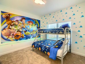 A child's bedroom with a bunk bed, a large animated movie mural, and a window with blinds. - 5BRStorey Lake Resort | Private Pool | Near Disney (Kissimmee)