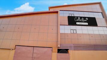 A large industrial building with a sign that reads 'Collection Company-Serviced'.