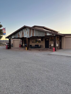 A two-story building with a covered outdoor seating area, a gas pump, and a fire hydrant. - Inviting 3-Bedroom Sonoita Escape: The Ideal Arizona Wine Country Getaway (Sonoita)