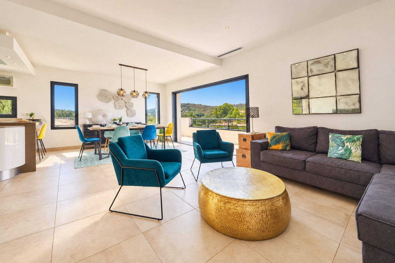 A spacious living area with a sofa, chairs, and a dining table.