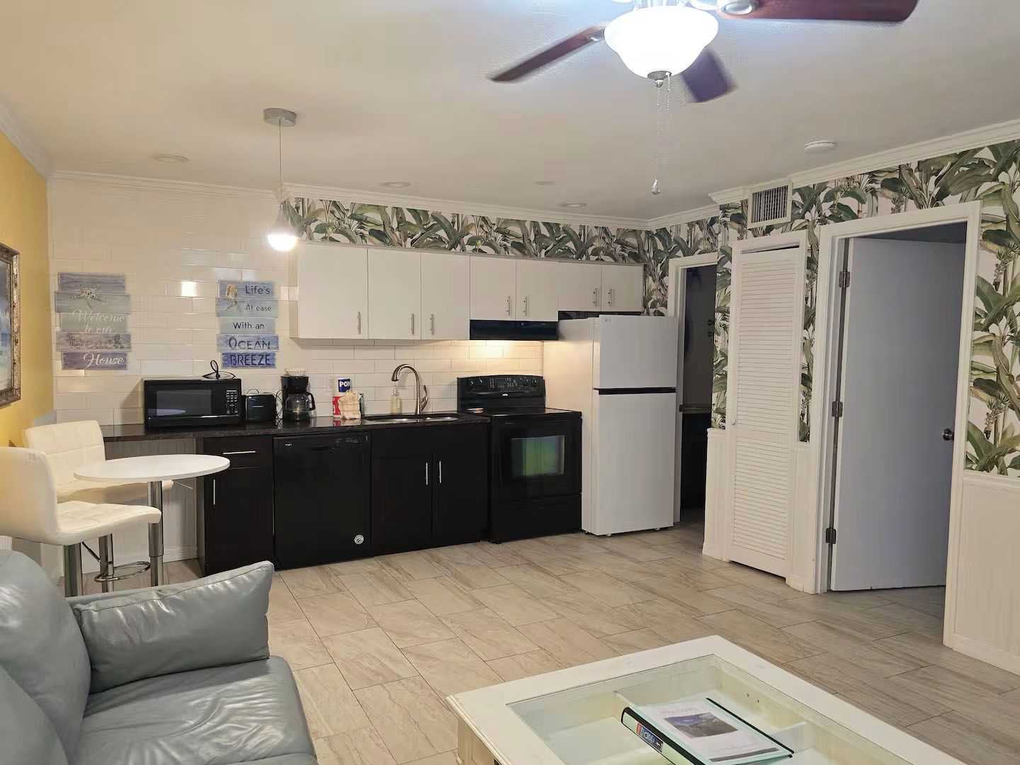 A compact living space with a kitchenette, a dining area, and a seating area.