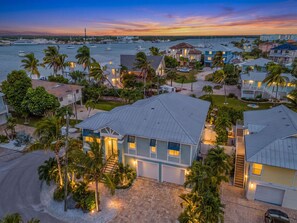 A coastal residential area with houses, palm trees, and a marina with boats. - Family-Friendly Retreat in Prime Carolina Location (Fort Myers Beach)
