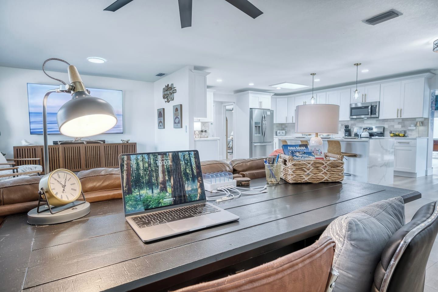A modern kitchen with white cabinets, a microwave, and a coffee machine.