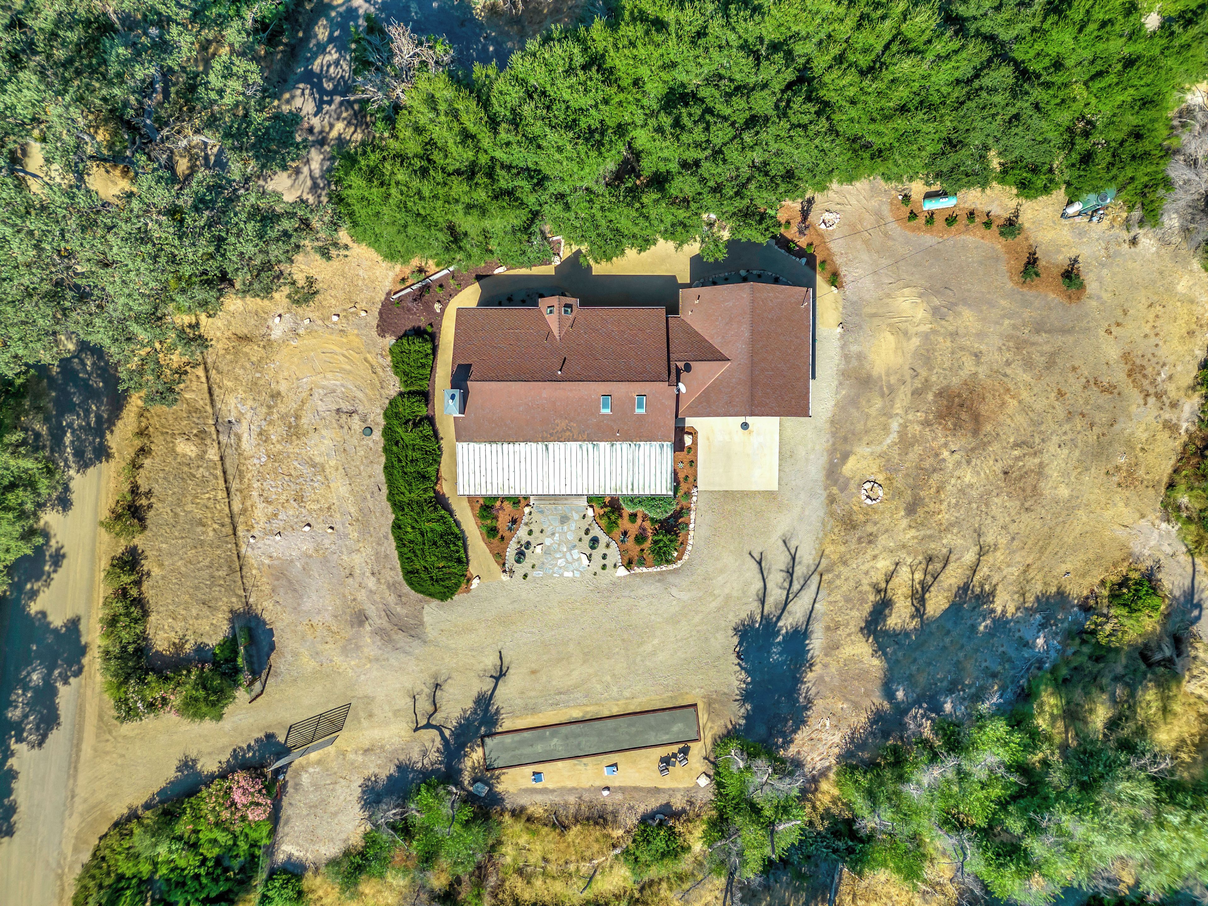 A large house with a spacious backyard, a separate garage, and a well-maintained lawn.