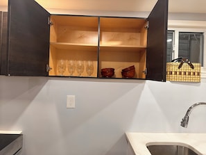 A kitchen with a built-in cabinet, a countertop, a sink, and a window. - Historical 2BR APT in Brooklyn NY (Brooklyn)