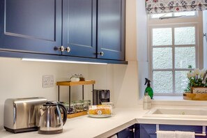 A kitchen with a coffee maker, a kettle, and a bread loaf on the counter. - 2 Bed in Kelso (oc-k46033) (Kelso)