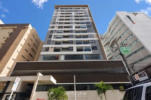 A multi-story building with a modern architectural design, featuring a prominent entrance with a covered area and a sign for 'Sedzone.' - Apt in Condo w/ Pool 110m From Beach Ssi0607 (Maceió)