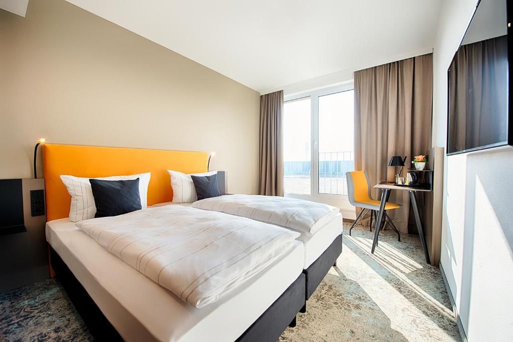 Relax in bright comfort with beds facing the balcony light.