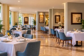 A hotel dining room with multiple tables set for guests, featuring a clean and elegant interior design. - Luxury 1 Bedroom Getaway at Club Velas Vallarta, All Inclusive Mexico Paradise (Puerto Vallarta)