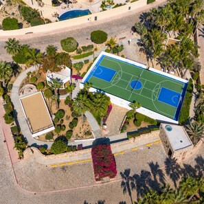 An aerial view of a property with a basketball court, palm trees, and a swimming pool. - New Listing (Cabo San Lucas)