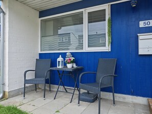 A blue exterior wall with a window, a mailbox, and a number '50' sign. - "Kielo" - 700m from the sea by Interhome (Væggerløse)